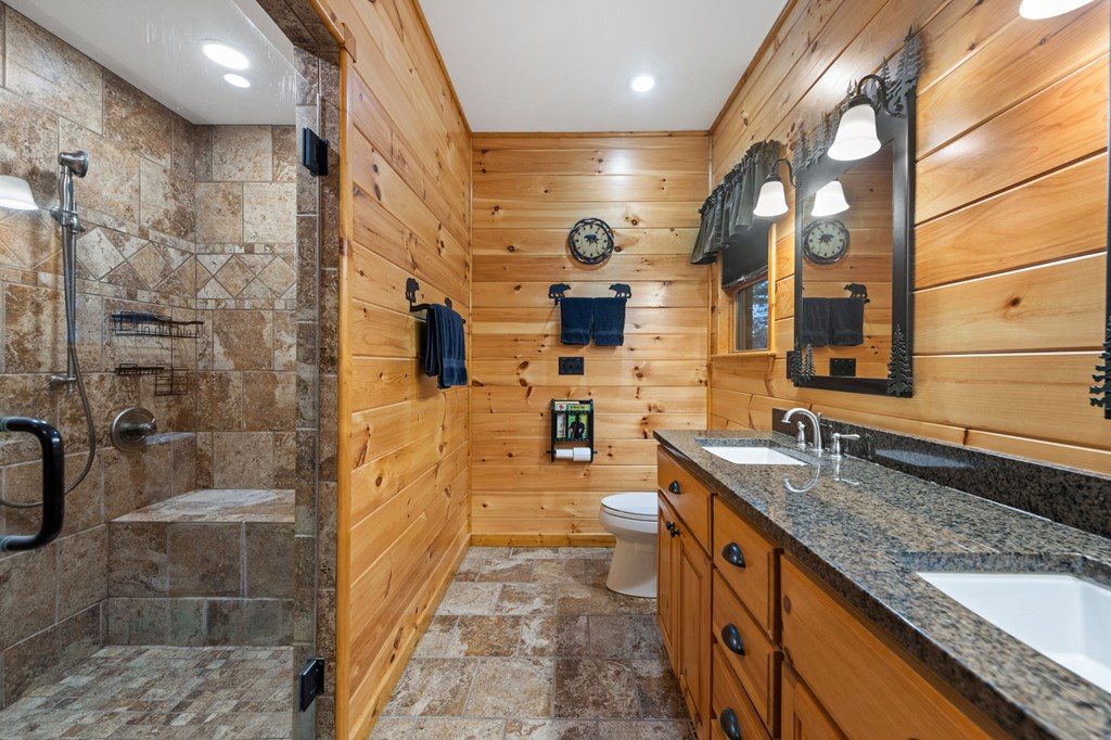 34 Smokey Ridge Lane Morganton, GA 30560 - Photo 20 of 47 a bathroom with a granite countertop sink a mirror and shower