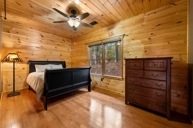 a bed room with a bed and a ceiling fan