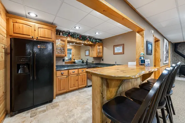 a kitchen with stainless steel appliances granite countertop a refrigerator a stove and sink