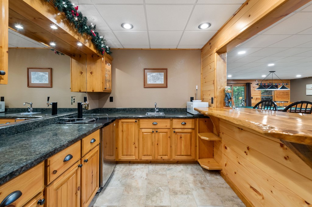 34 Smokey Ridge Lane Morganton, GA 30560 - Photo 33 of 47 a large kitchen with stainless steel appliances granite countertop a sink and cabinets