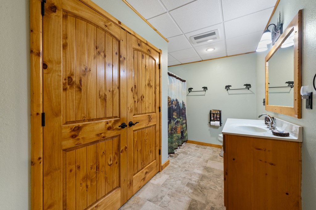 34 Smokey Ridge Lane Morganton, GA 30560 - Photo 38 of 47 a bathroom with a sink a mirror and a shower