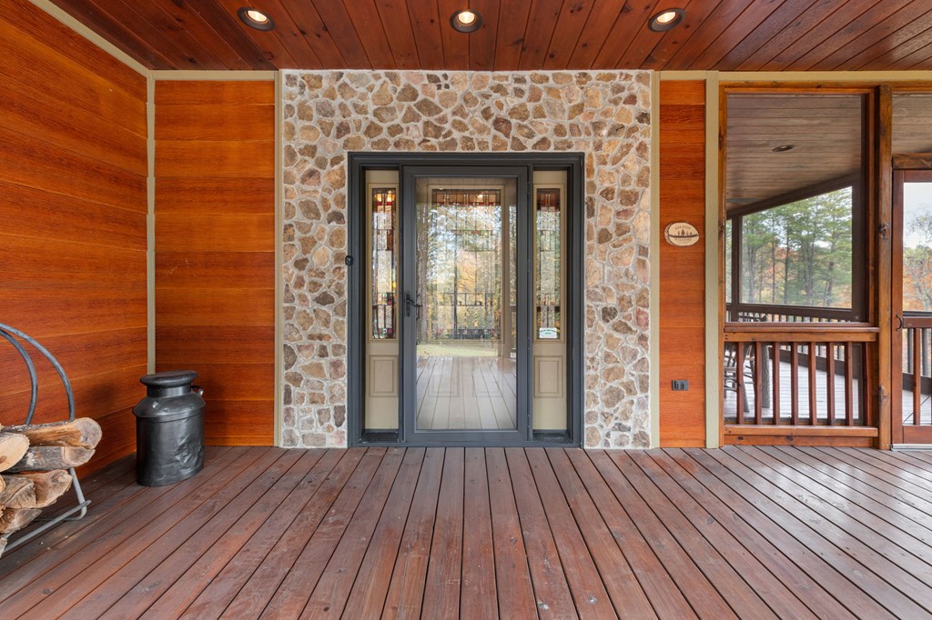 34 Smokey Ridge Lane Morganton, GA 30560 - Photo 4 of 47 a view of a porch with wooden floor and iron stairs
