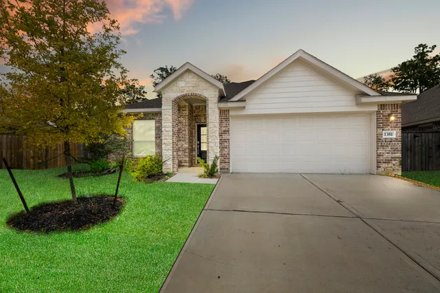 a front view of house with yard and green space