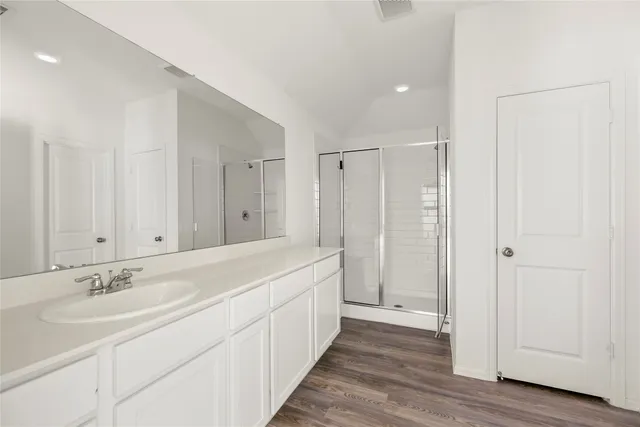 a bathroom with a double vanity sink and mirror