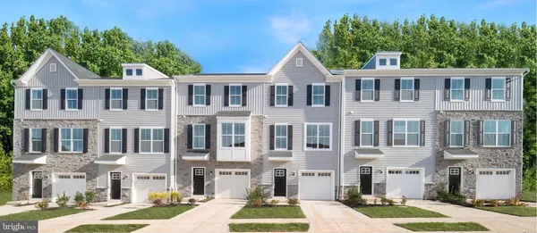 a front view of a residential apartment building with a yard