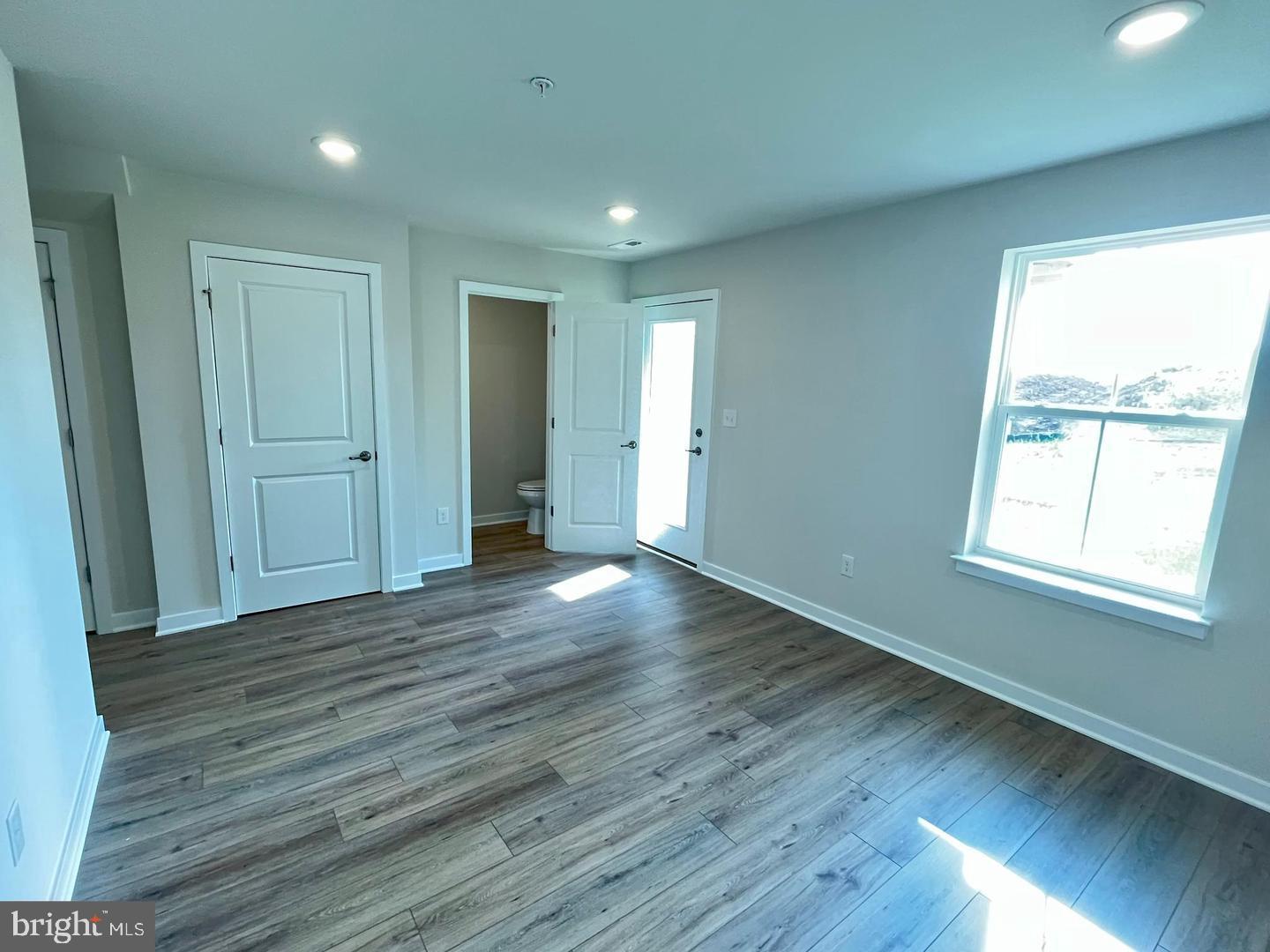 905 Magnolia Lane Spring City, PA 19475 - Photo 3 of 22 an empty room with wooden floor and windows