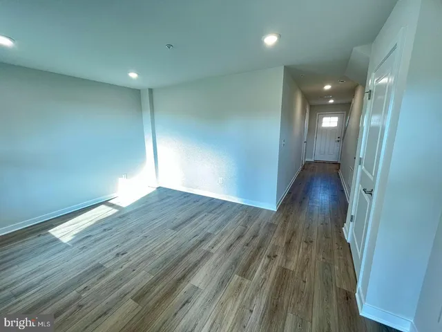 a view of wooden floor and windows in a room