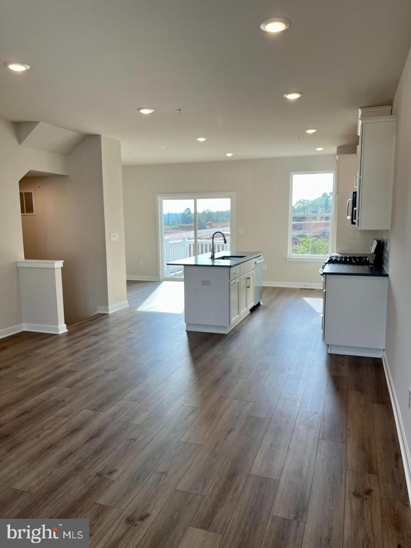 905 Magnolia Lane Spring City, PA 19475 - Photo 6 of 22 a living room with stainless steel appliances furniture wooden floor and a kitchen view