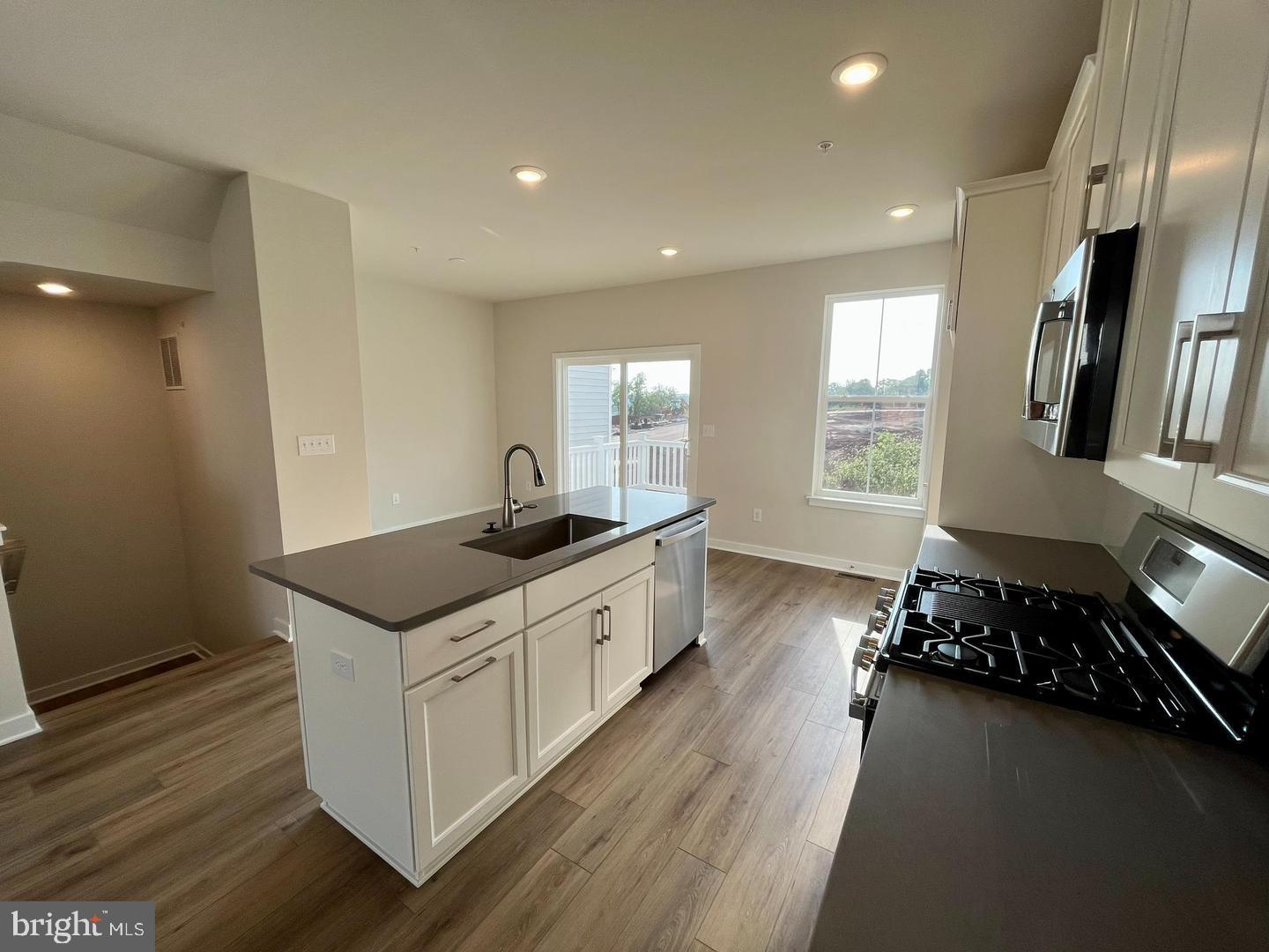 905 Magnolia Lane Spring City, PA 19475 - Photo 8 of 22 a kitchen with a sink stove and cabinets