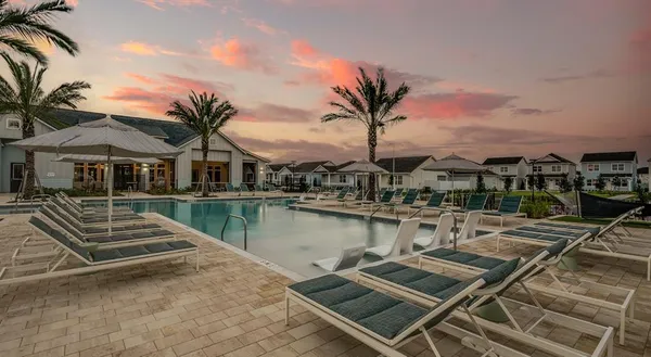 a view of a house with pool and ocean view