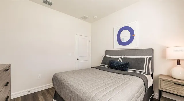 a bedroom with a bed and a lamp