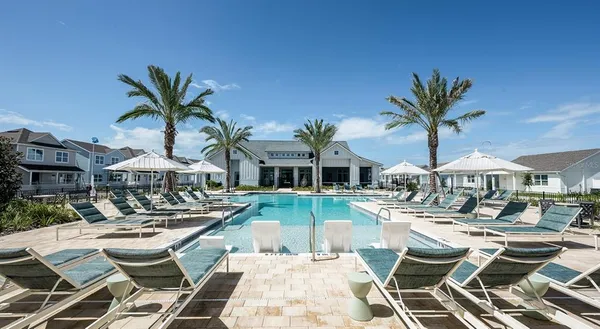 a view of a patio with table and chairs under an umbrella with a palm tree