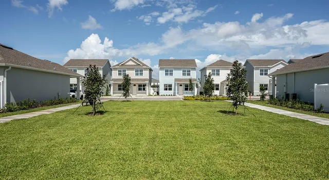 a view of a house with a swimming pool and a yard