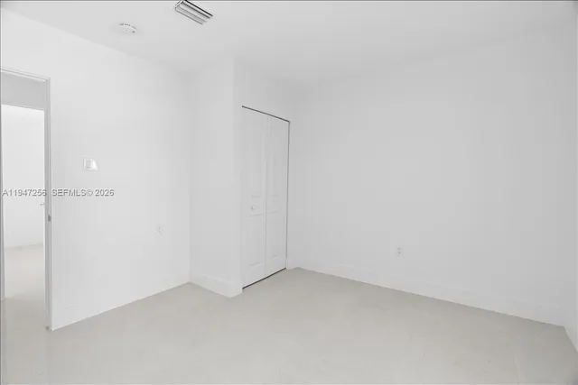 a bathroom with a granite countertop toilet a sink and shower