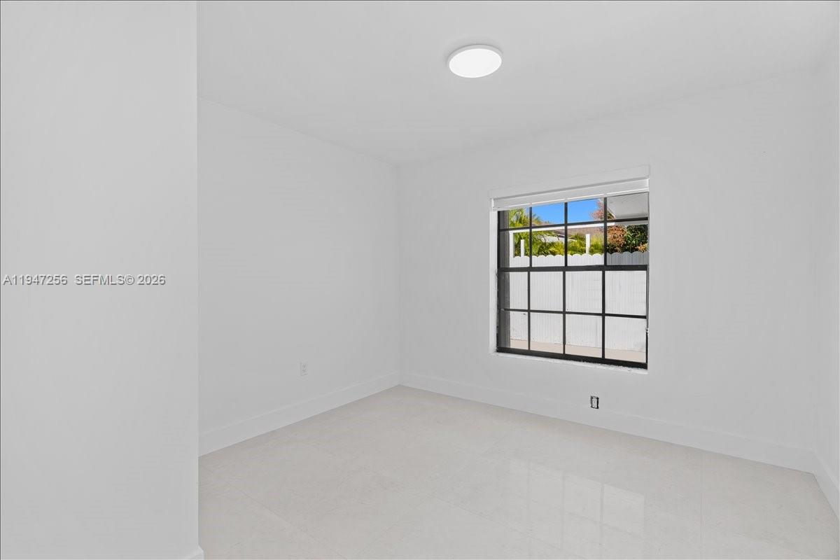 10351 Southwest 164th Street Miami, FL 33157 - Photo 14 of 19 an empty room with windows