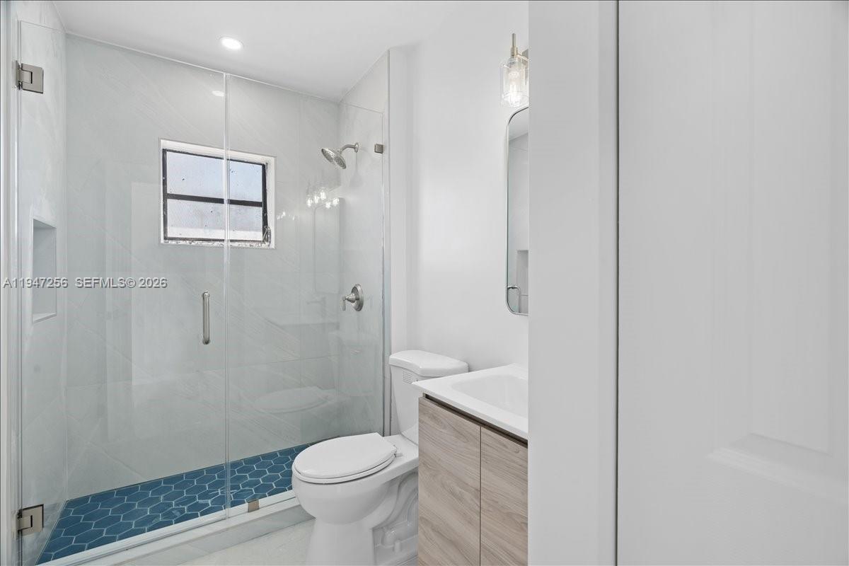 10351 Southwest 164th Street Miami, FL 33157 - Photo 15 of 19 a bathroom with a granite countertop toilet a sink and shower