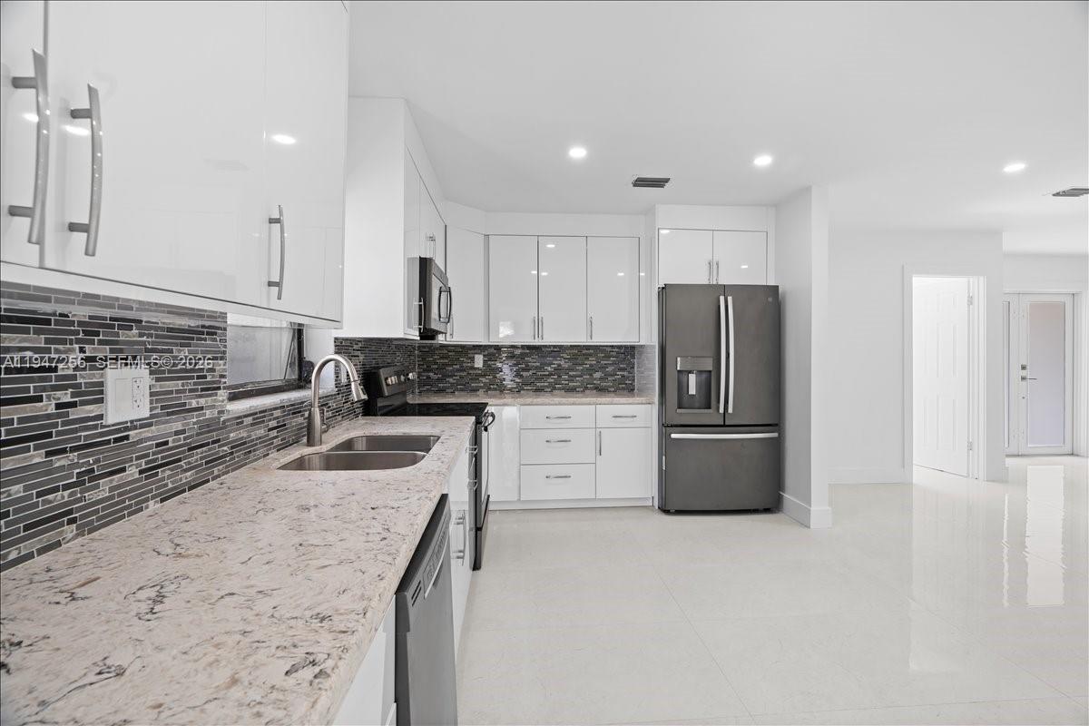 10351 Southwest 164th Street Miami, FL 33157 - Photo 3 of 19 a kitchen with a refrigerator and a sink