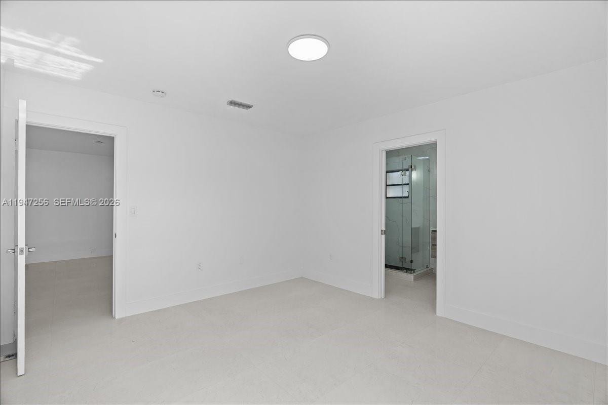 10351 Southwest 164th Street Miami, FL 33157 - Photo 7 of 19 a view of an empty room with a fan