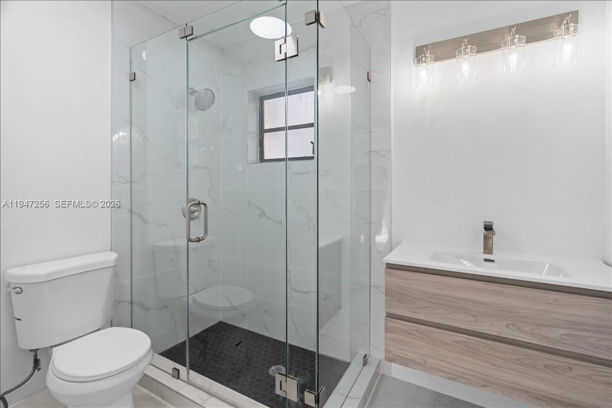 10351 Southwest 164th Street Miami, FL 33157 - Photo 9 of 19 a bathroom with a sink a toilet and shower