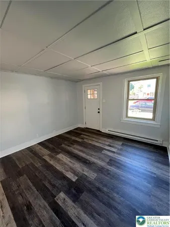 a view of a room with wooden floor and window