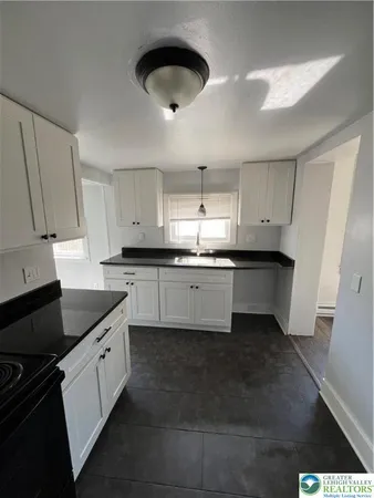 a kitchen with a sink dishwasher a stove and a refrigerator
