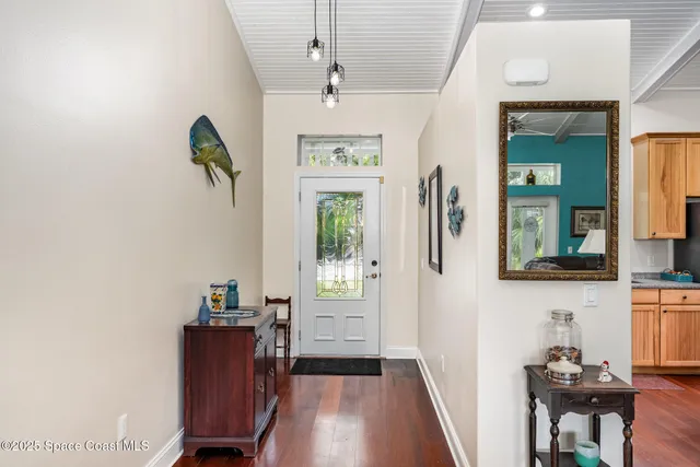 a view of hallway with furniture and wooden floor