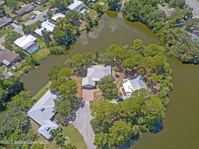 an aerial view of a house with a lake view