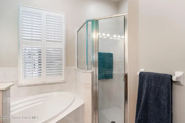 a bathroom with a bathtub and a shower