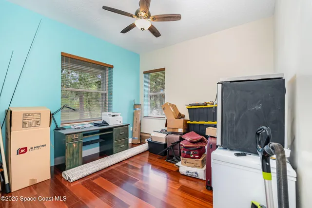 a view of a workspace with furniture and a kitchen