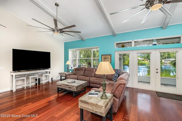a living room with furniture flat screen tv and wooden floor