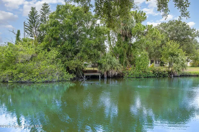 a view of a lake with a house in the background
