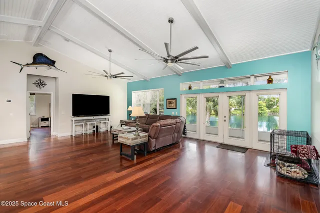 a living room with furniture or wooden floor and a flat screen tv