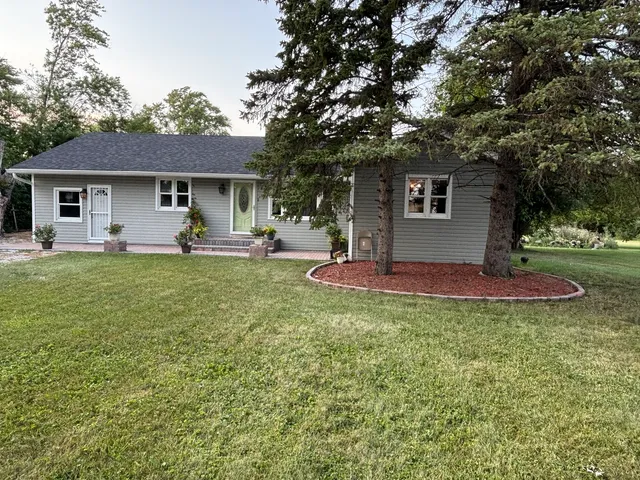 a house view with a sitting space and garden