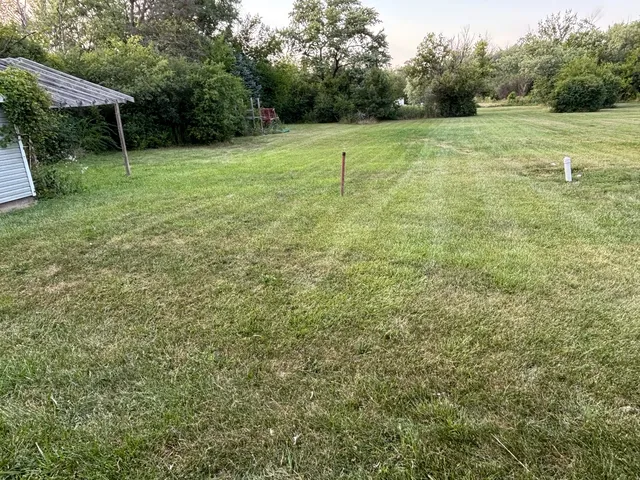a backyard of a house with lots of green space and mountain view