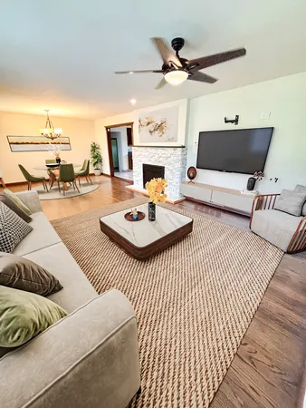 a living room with furniture a fireplace and a flat screen tv