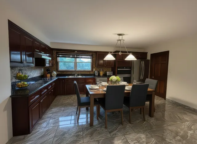 a kitchen with a dining table and chairs