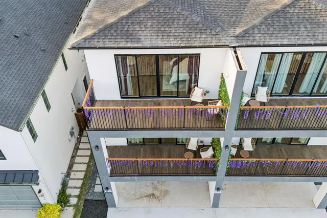 an aerial view of multiple houses with a yard