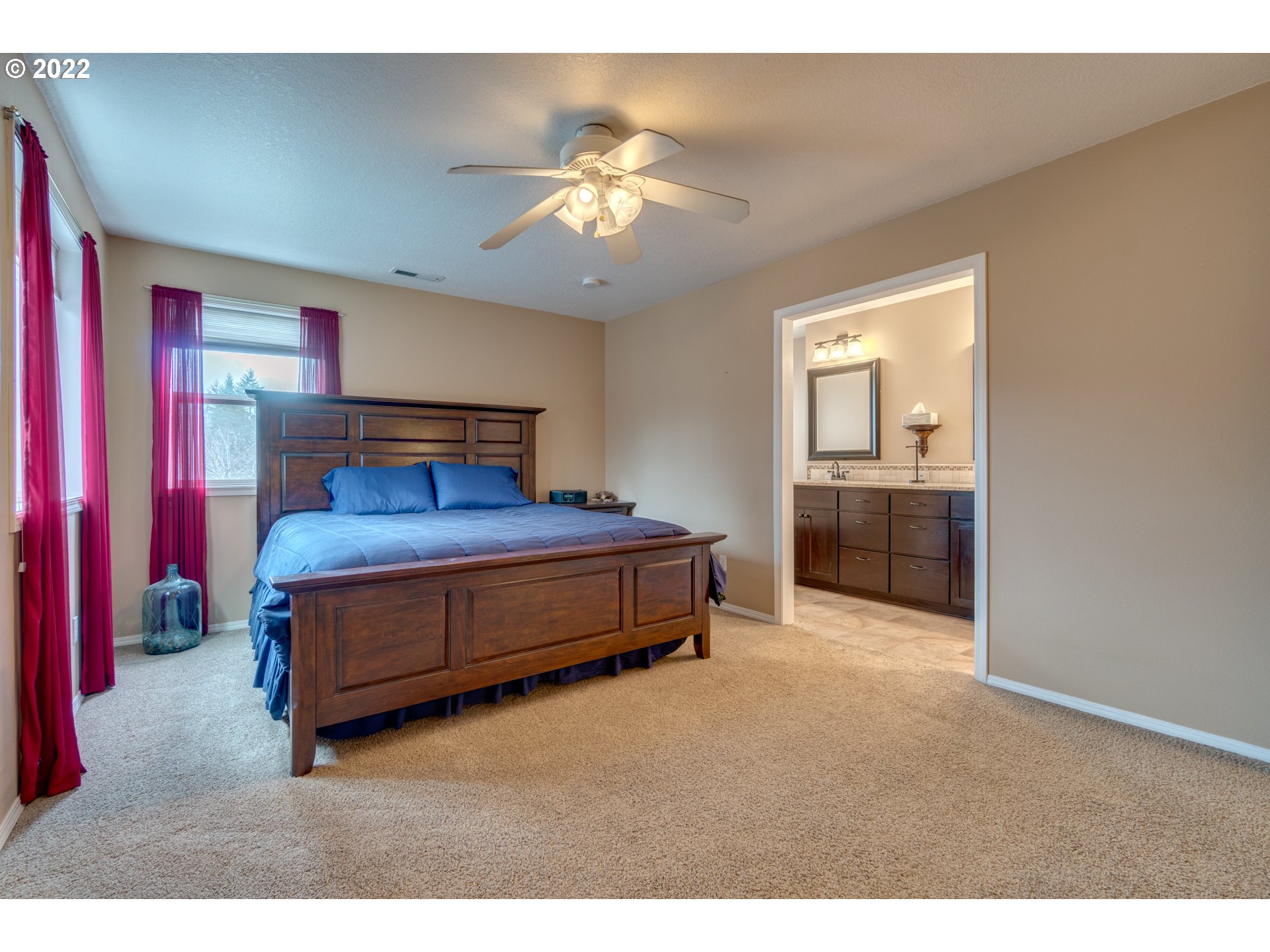 20195 Canyon Ridge Drive Oregon City, OR 97045 - Photo 17 of 24 a bedroom with a bed and a chandelier