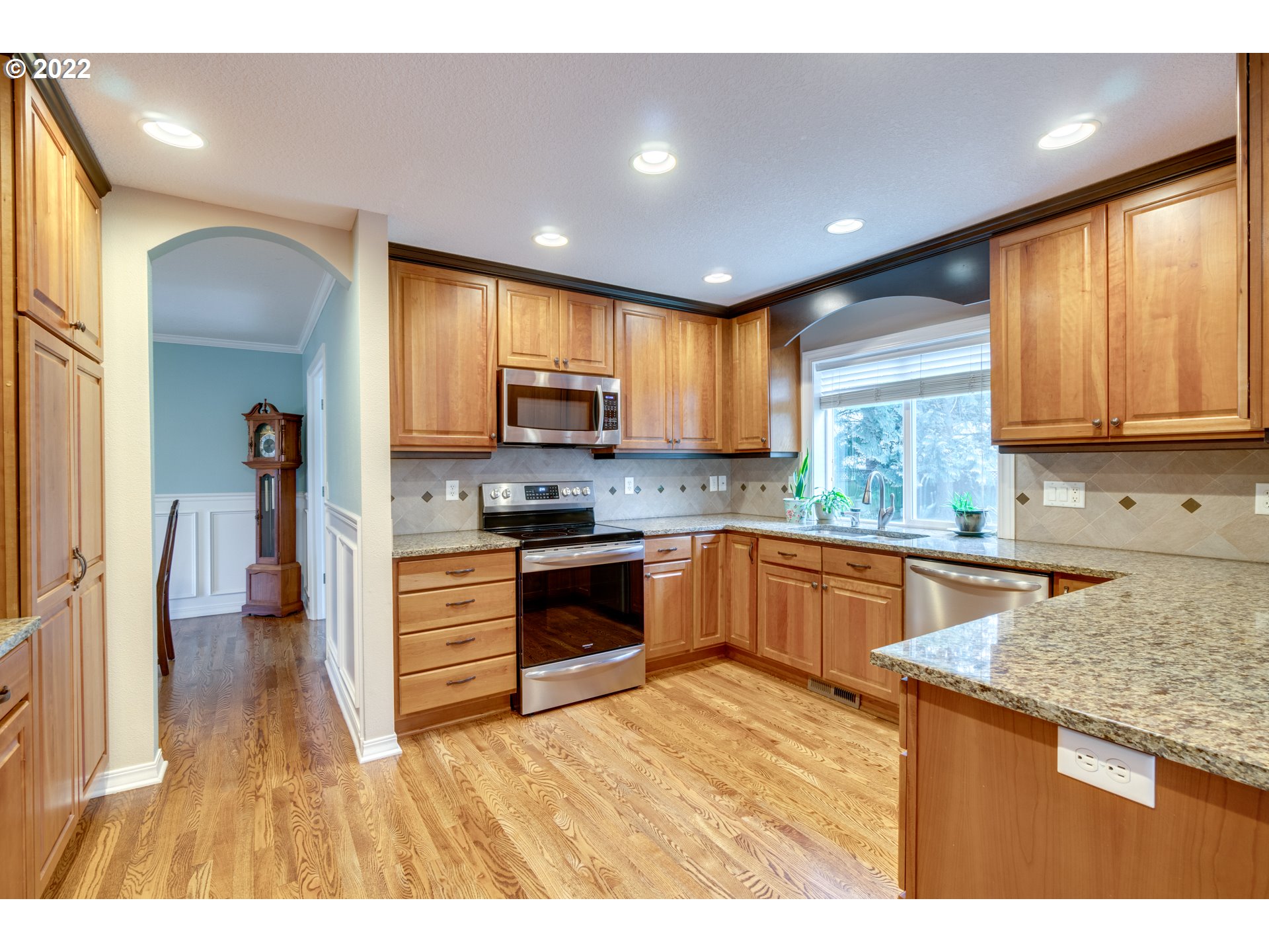 20195 Canyon Ridge Drive Oregon City, OR 97045 - Photo 7 of 24 a kitchen with kitchen island granite countertop a sink cabinets and stainless steel appliances