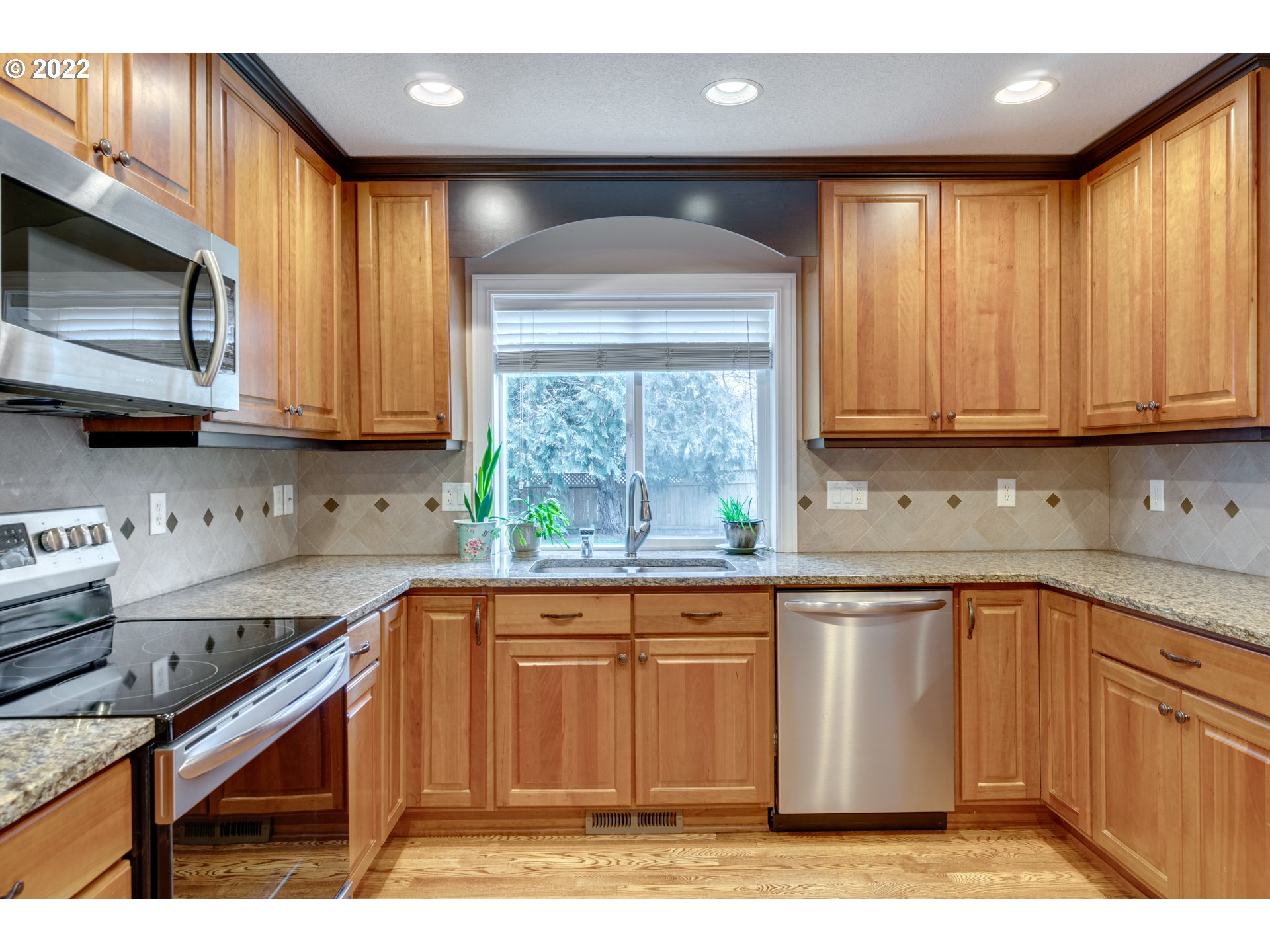 20195 Canyon Ridge Drive Oregon City, OR 97045 - Photo 8 of 24 a kitchen with stainless steel appliances granite countertop a stove a sink and a microwave