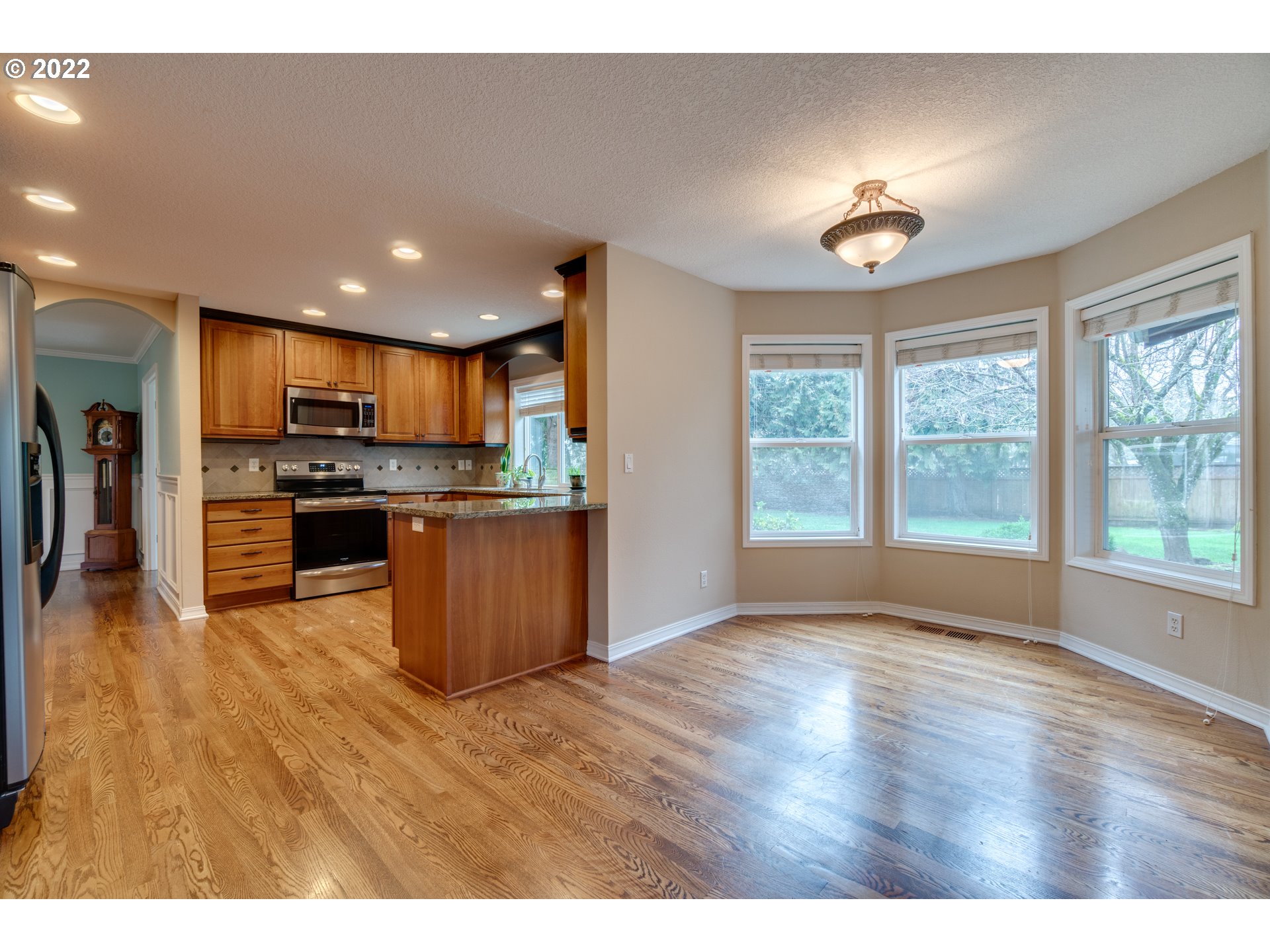 20195 Canyon Ridge Drive Oregon City, OR 97045 - Photo 10 of 24 a kitchen with stainless steel appliances granite countertop a refrigerator a stove top oven a sink and a large window