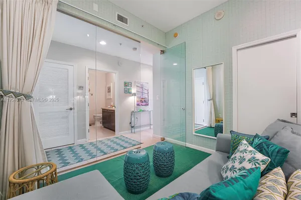 a spacious bedroom with a bed and a mirror