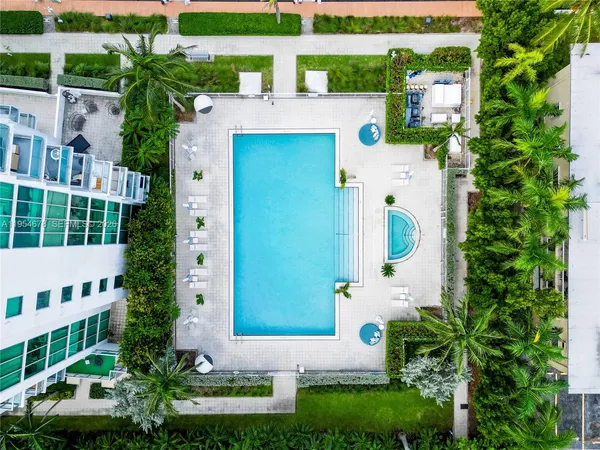 an aerial view of a house with a yard and potted plants