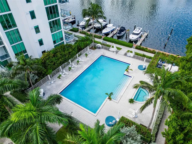a living room with furniture and large windows
