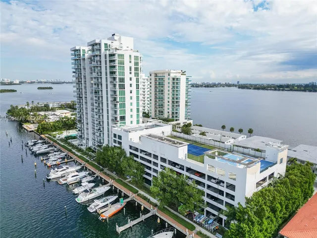 a balcony with furniture and a lake view