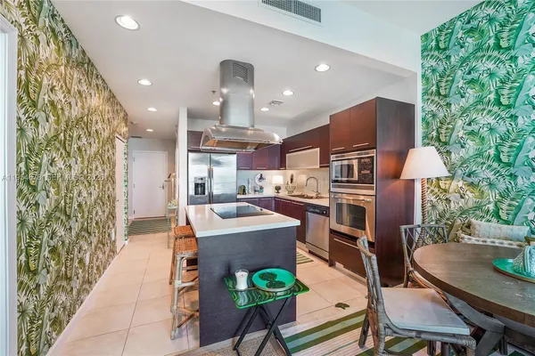 a living room with kitchen island furniture and a stove
