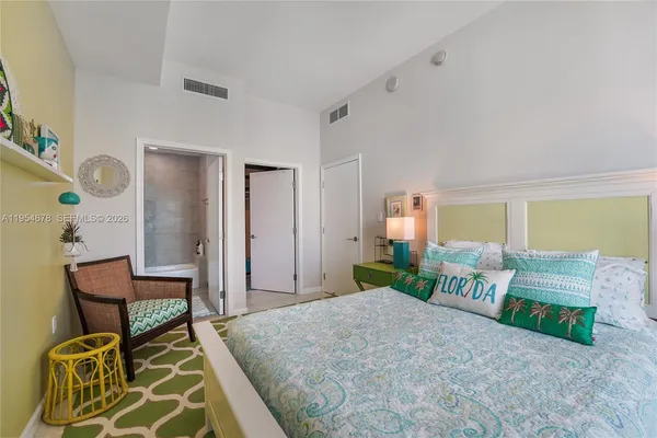 a bedroom with a bed and chair