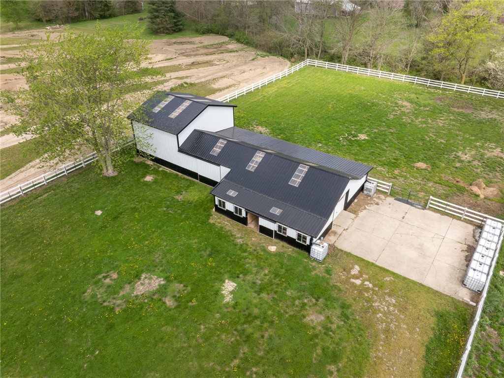 7988 McCool Road Greenville, OH 45331 - Photo 47 of 50 An aerial view captures a large barn-style structure amidst expansive green fields.