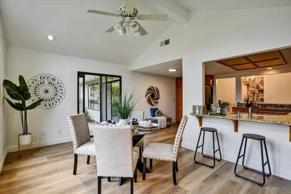 a dining room with furniture window and wooden floor