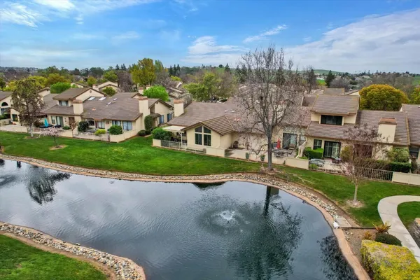 an aerial view of a house with a yard basket ball court and outdoor seating